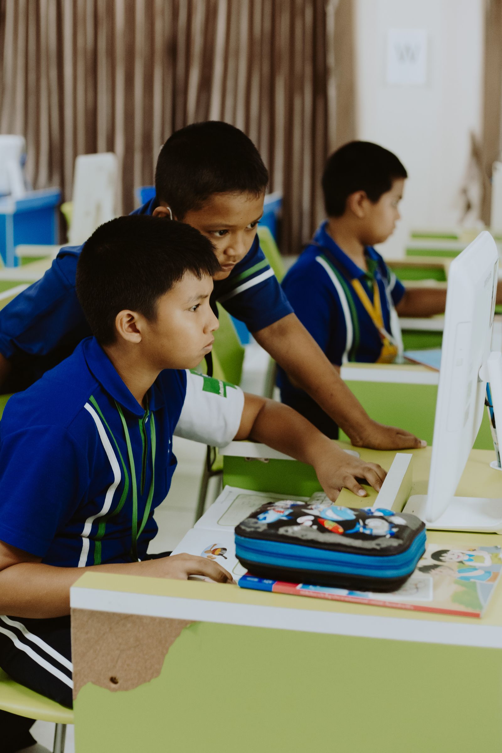 Learners seated at desks in a primary school classroom