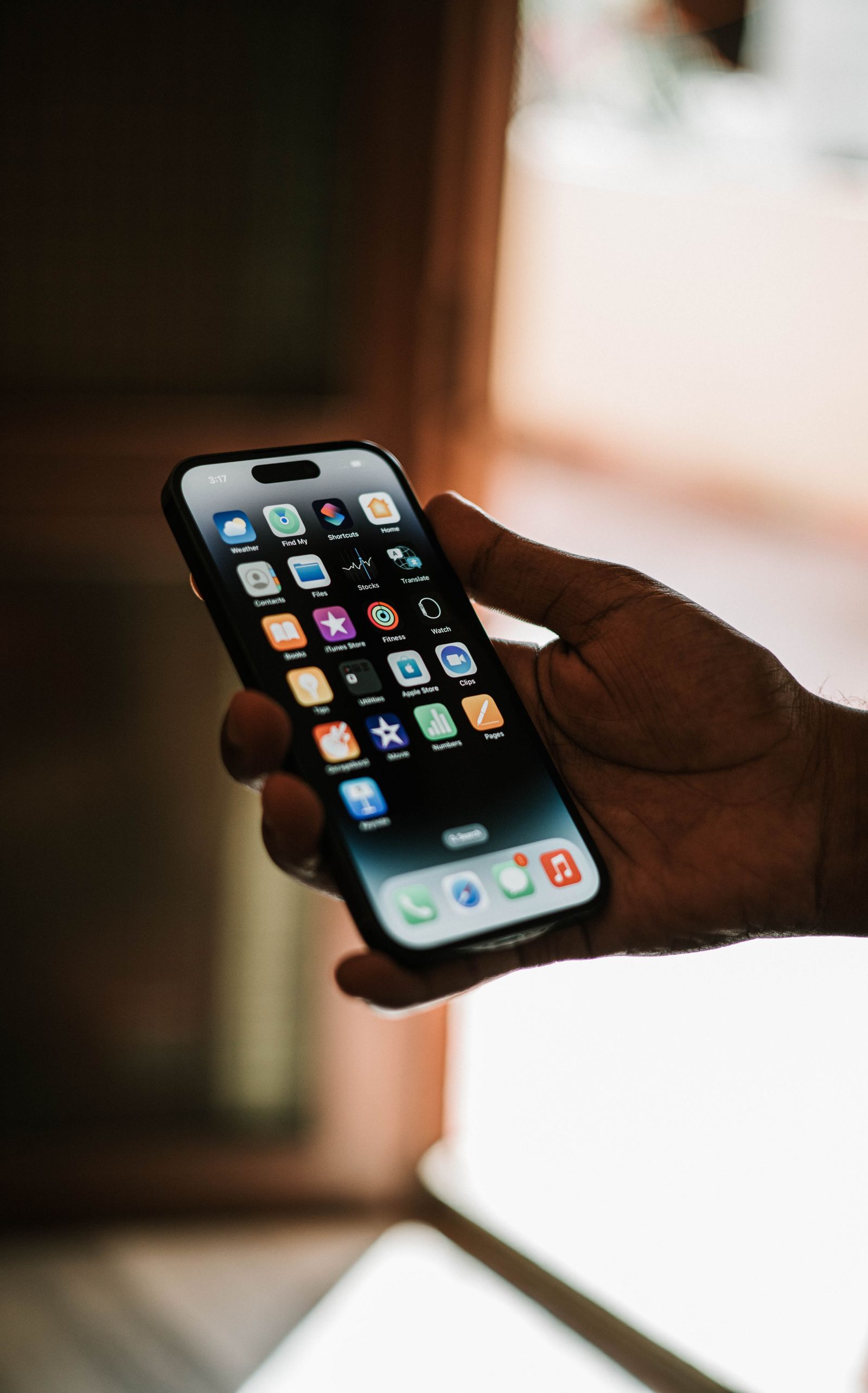 Hand holding a smartphone with a business app open on the screen