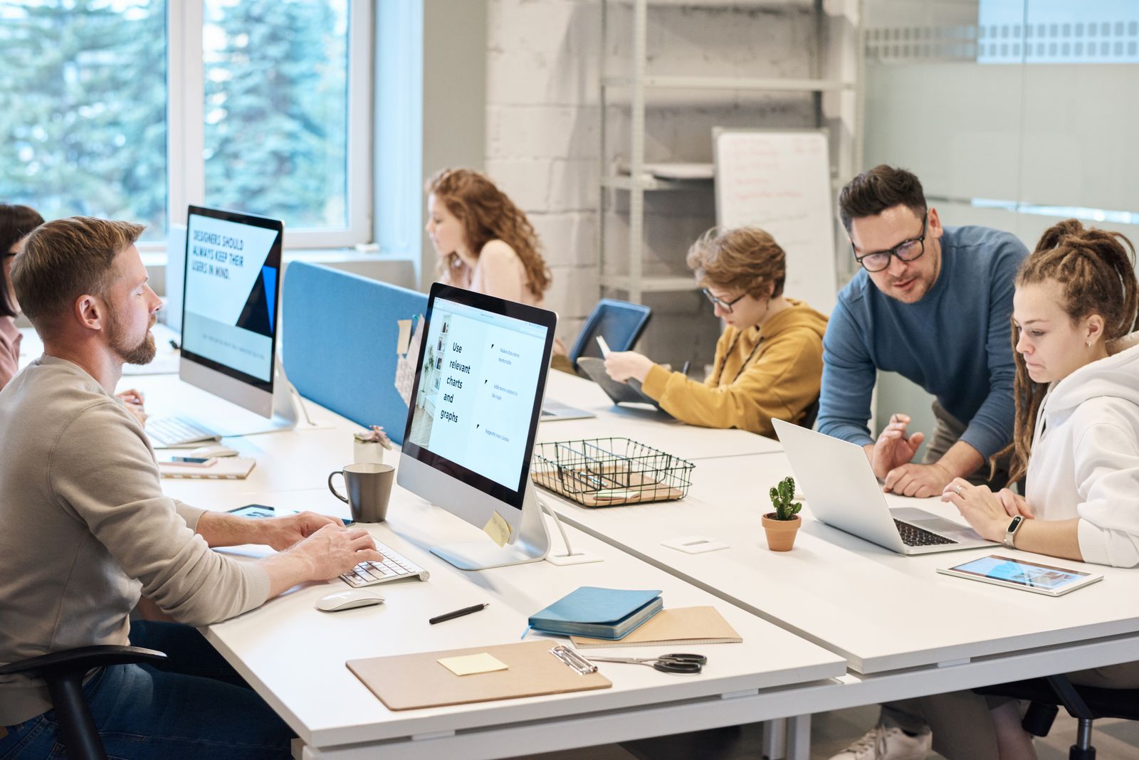 Team collaborating in a modern office with computers